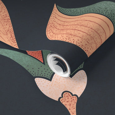 Close-up of a roll of patterned paper with a can on a dark background