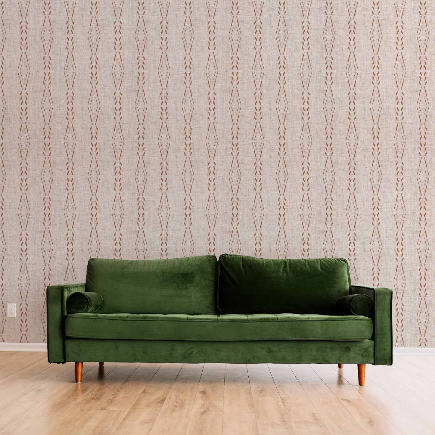 Green sofa against a patterned wall.