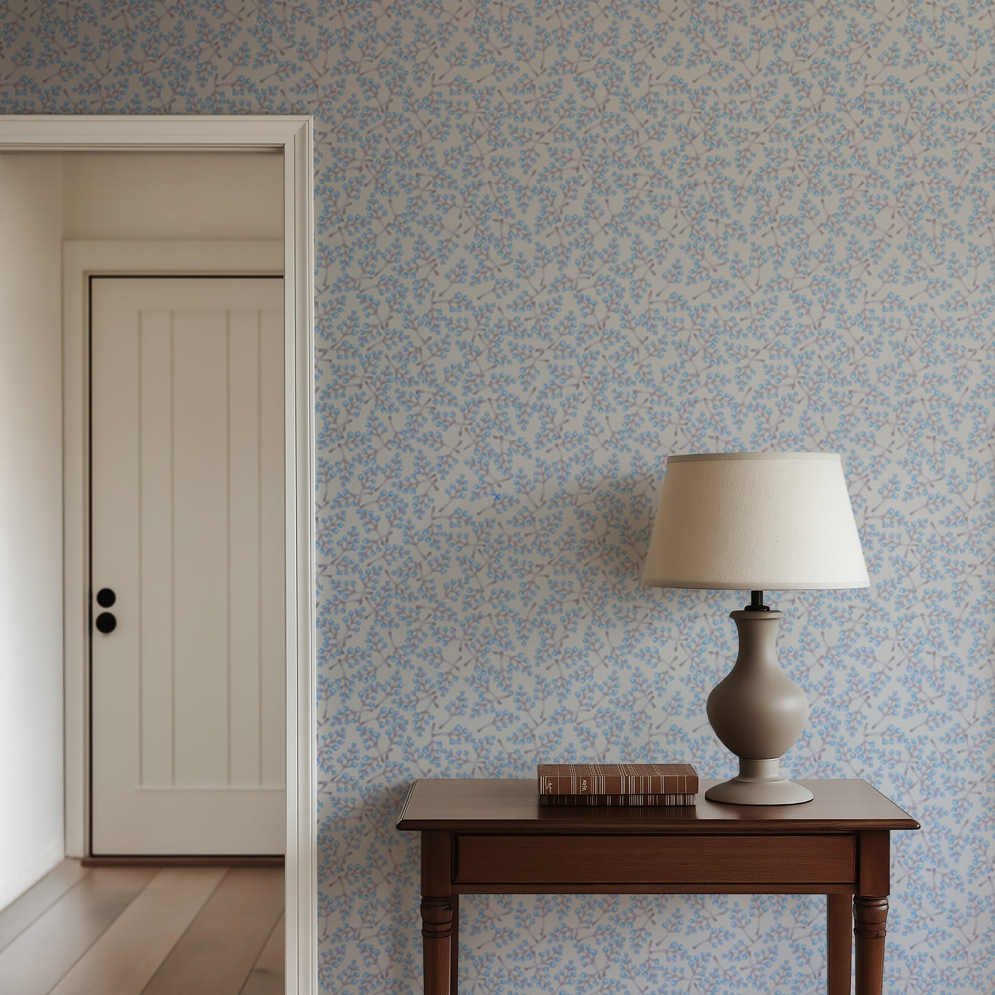 Room interior with floral wallpaper, wooden table, and lamp.