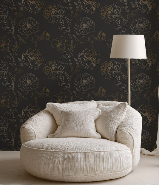 Beige armchair with decorative pillows against a dark floral wallpaper wall.