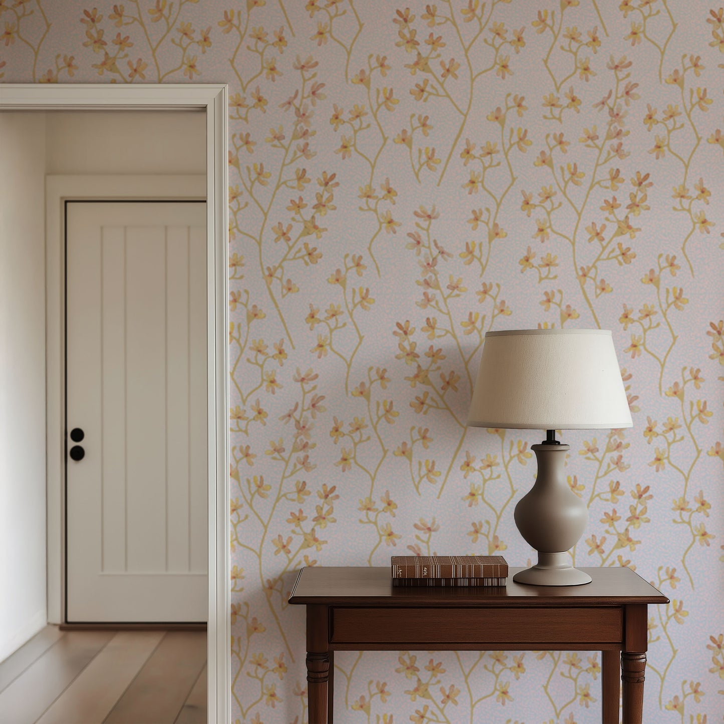 Wallpaper with floral pattern in a room with a wooden table and lamp.