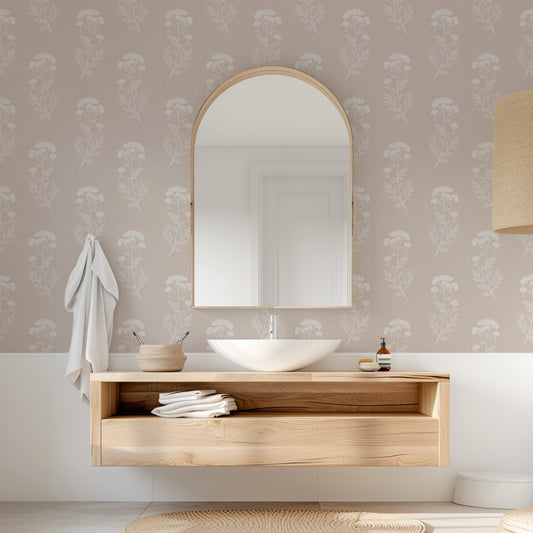 Bathroom with wooden vanity, round mirror, and floral wallpaper