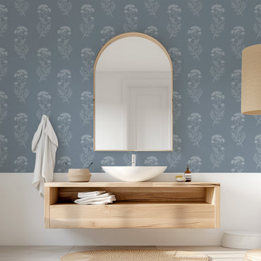 Bathroom with wooden vanity, mirror, and floral wallpaper