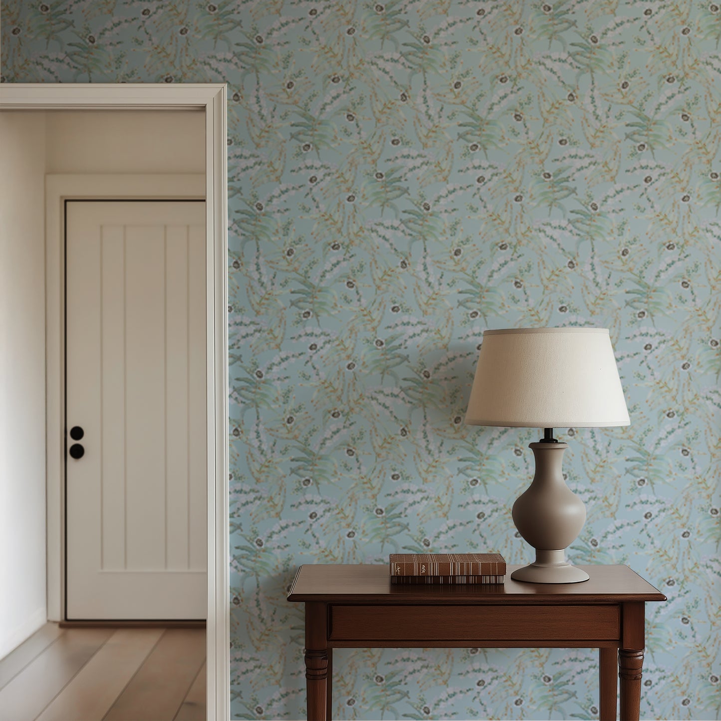 Room interior with floral-patterned wallpaper, wooden table, and lamp.
