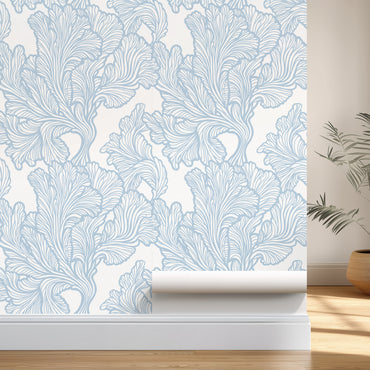 Roll of wallpaper with blue leaf pattern on a white background