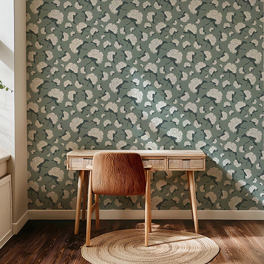 Room interior with a wooden desk and chair against a patterned wall.