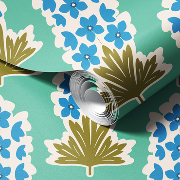 Roll of floral-patterned wallpaper with blue flowers and green leaves on a teal background