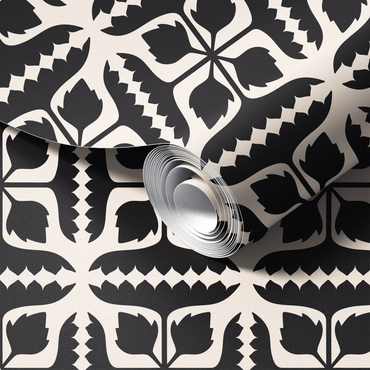 Roll of black and white wallpaper with a detailed design.