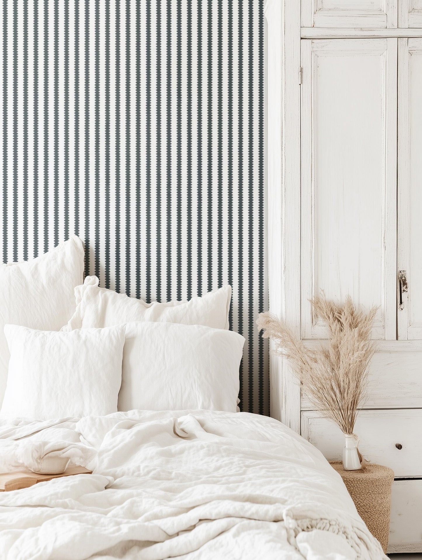 Neatly made bed with white bedding in a bedroom setting.