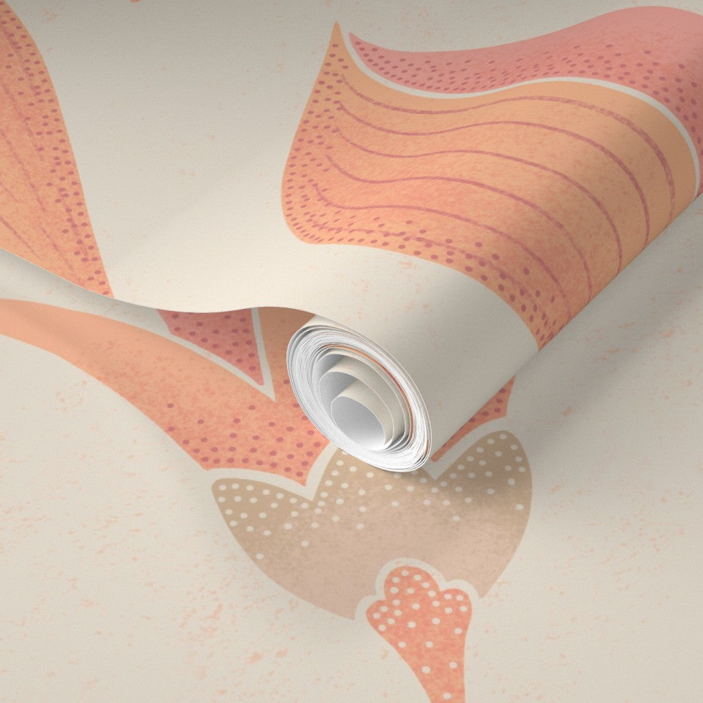 Roll of wallpaper with a pink and beige abstract pattern on a matching background