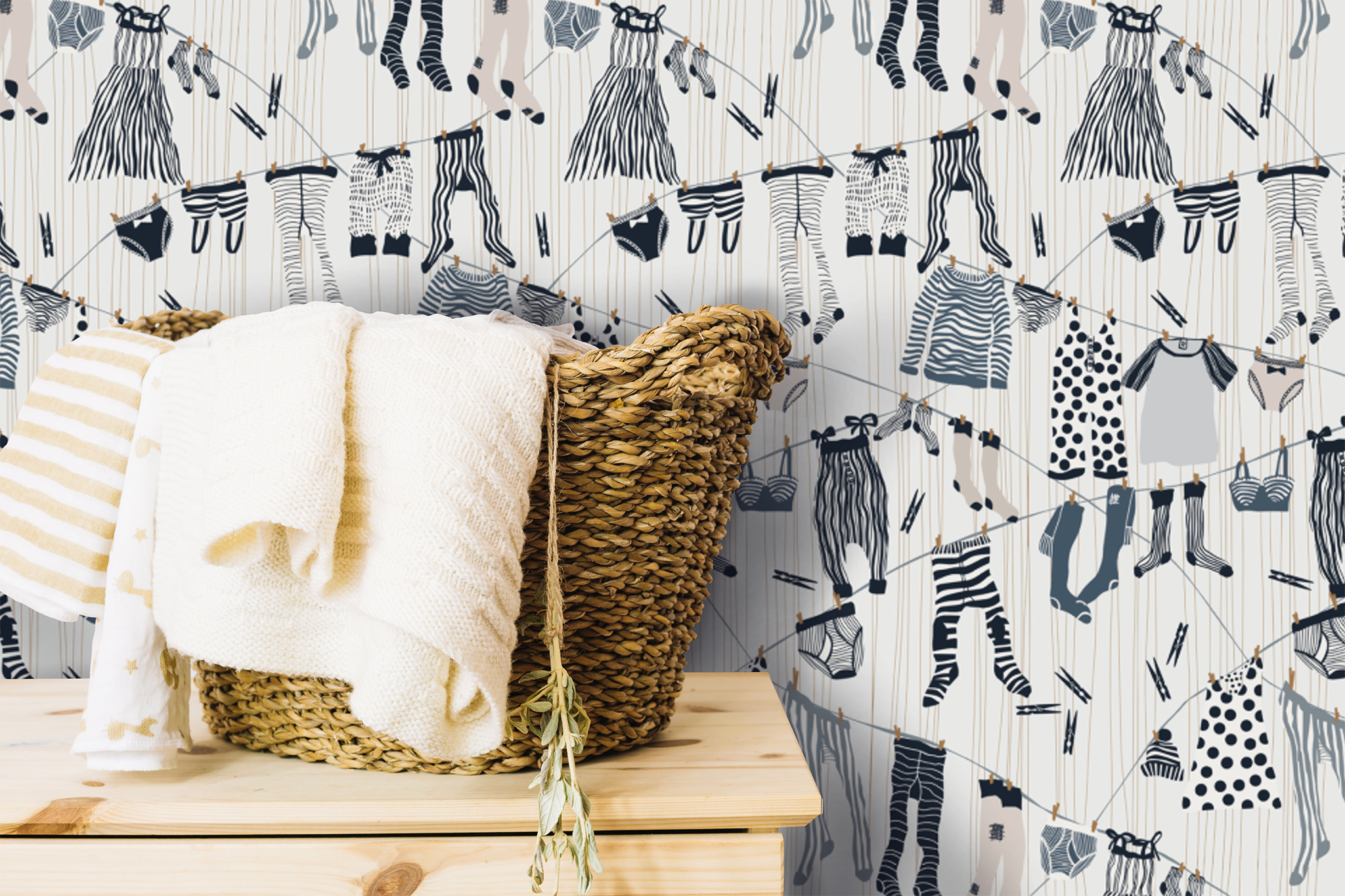 Wicker basket with a white blanket against a patterned wallpaper background