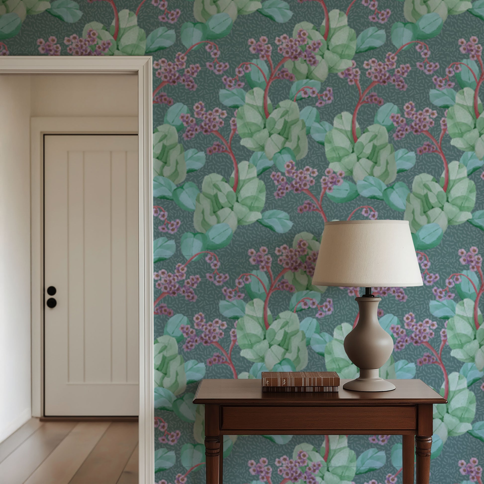 Room interior with floral wallpaper, wooden table, and lamp.