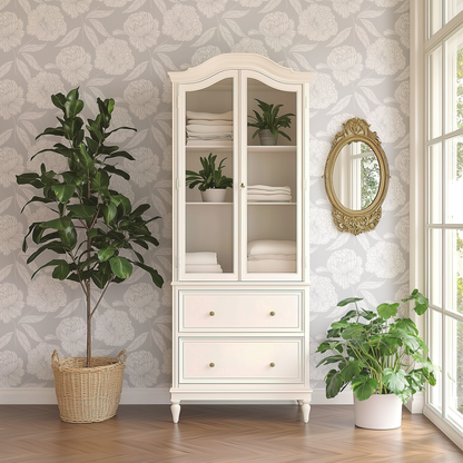 White cabinet with glass doors, plants, and a decorative mirror in a room with floral wallpaper.