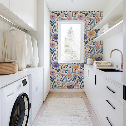 Modern laundry room with floral wallpaper, washing machine, and window.