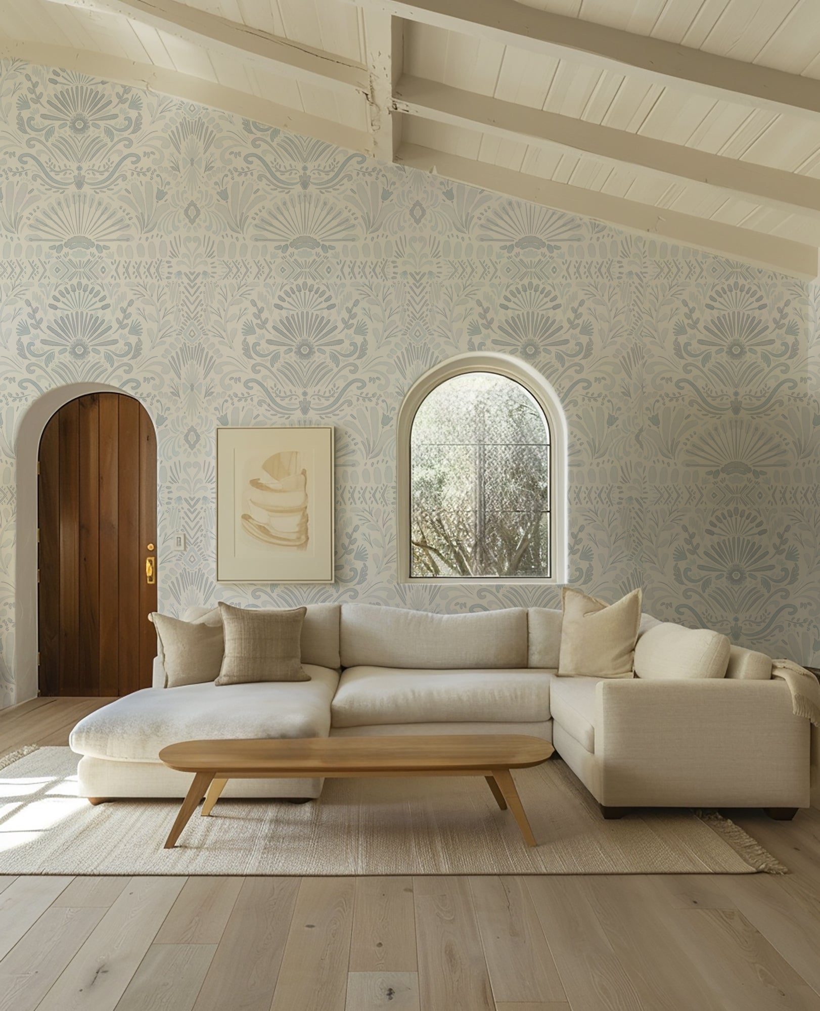 Modern living room with a beige sectional sofa, wooden coffee table, and decorative wall patterns.