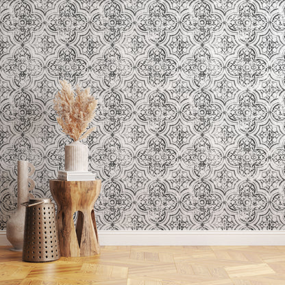 Decorative wallpaper with a geometric pattern in a room with wooden flooring and decorative items.