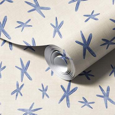 Roll of paper with blue starfish pattern on a beige background