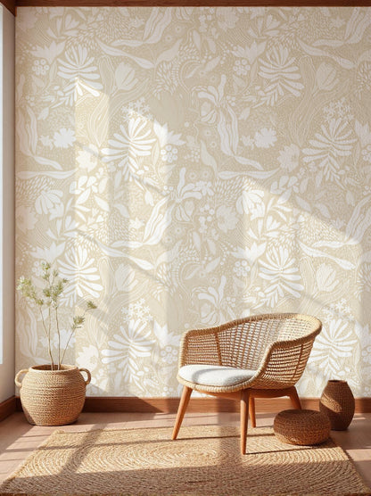 Wicker chair and ottoman against a wall with floral wallpaper