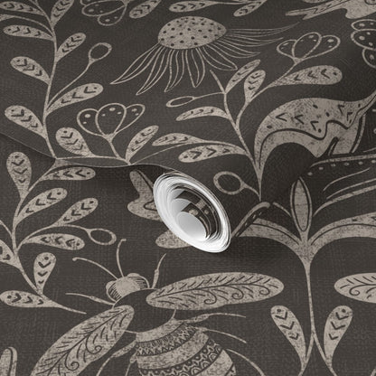 a dark background with floral and bee pattern wallpaper roll