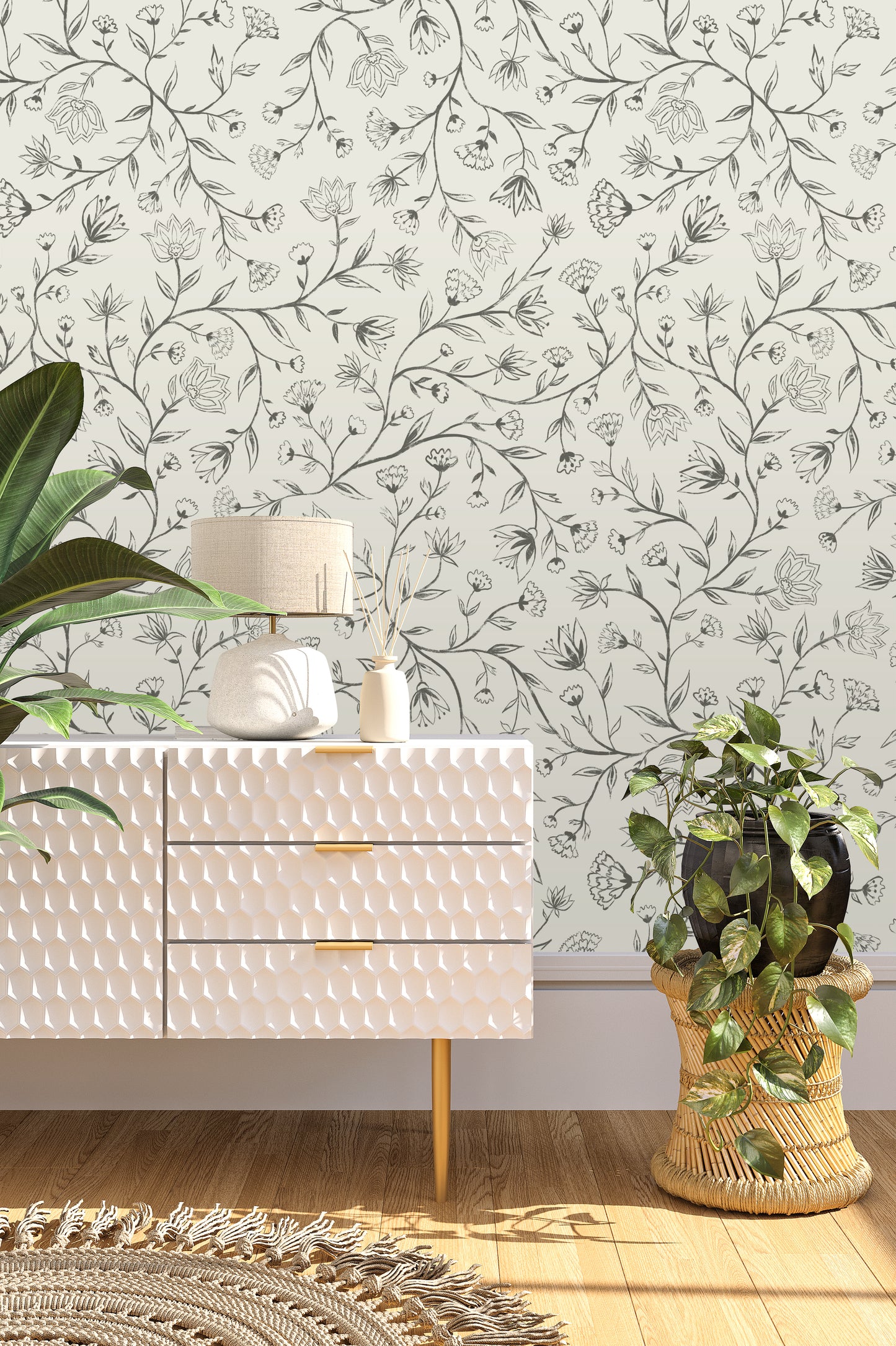 White textured dresser with decorative items against a floral wallpapered wall.