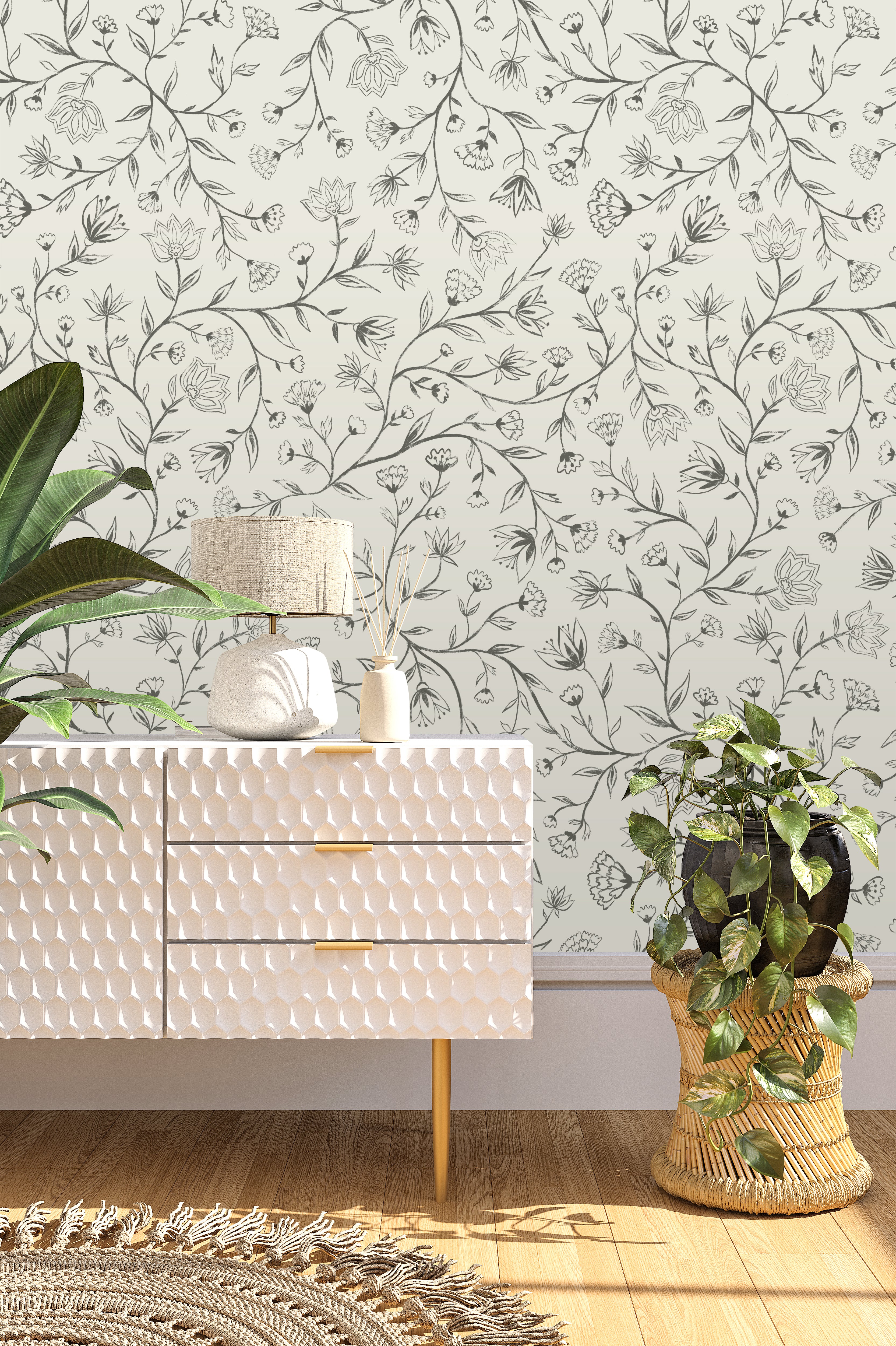 White textured dresser with decorative items against a floral wallpapered wall.