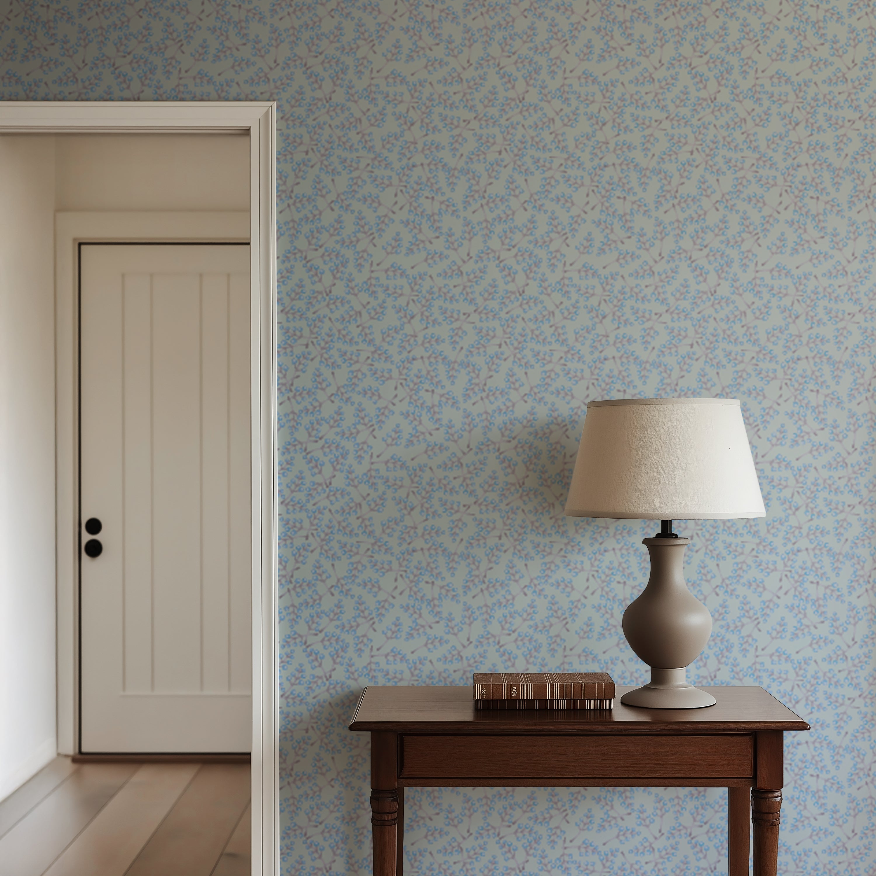 Room interior with floral wallpaper, wooden table, and lamp.