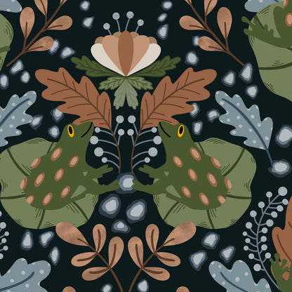 A repeating illustrated pattern featuring two green frogs with pink spots facing each other beneath large brown leaves, surrounded by muted blue-gray leaves, tan botanical elements, and small white dots on a very dark navy background.