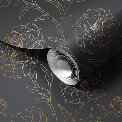 Roll of floral-patterned wallpaper with gold outlines on a dark background