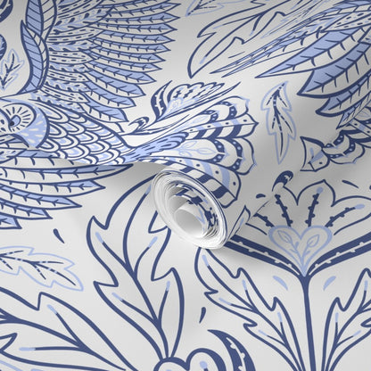 Roll of wallpaper with blue feather pattern on a white background