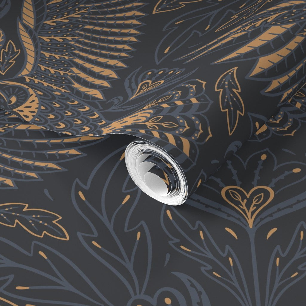Roll of wallpaper with gold leaf pattern on a dark background