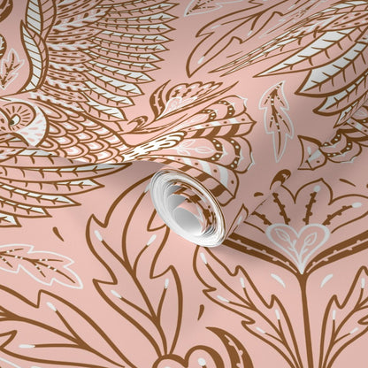 Roll of wallpaper with decorative feather pattern on a pink background