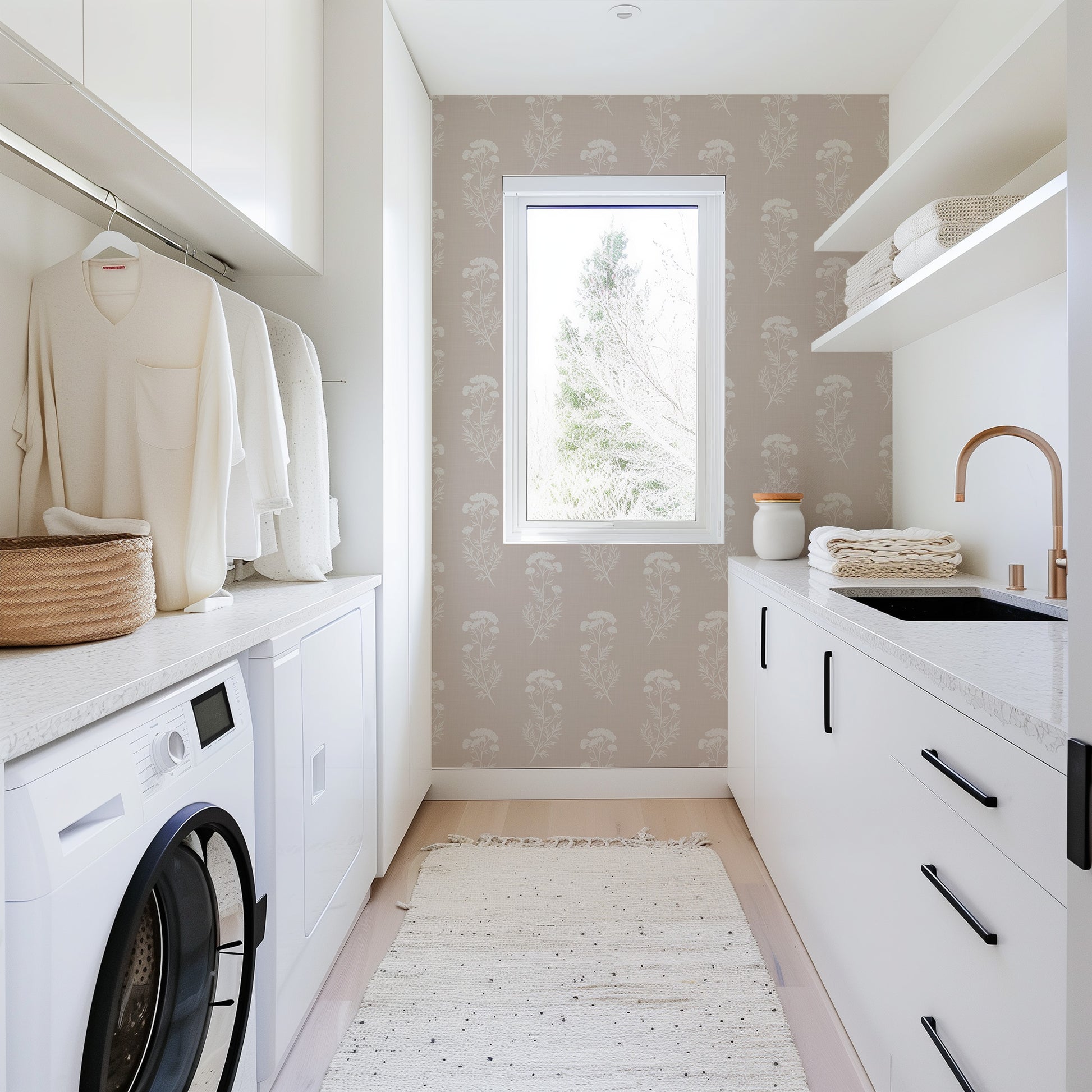 Modern laundry room with washing machine, dryer, and sink.