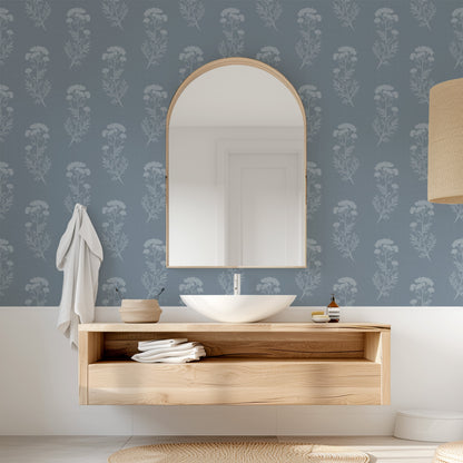Bathroom with wooden vanity, mirror, and floral wallpaper