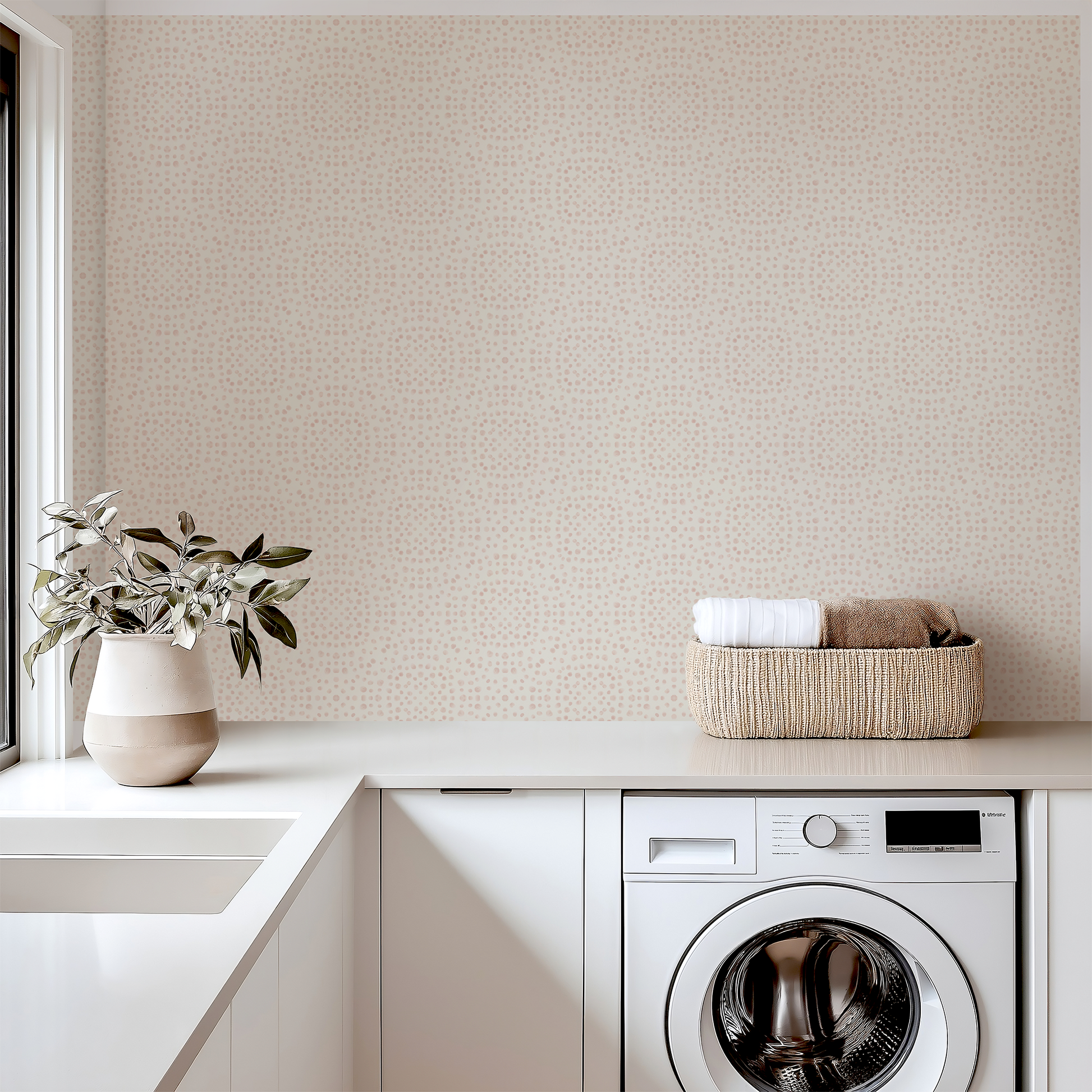 Modern laundry room with washing machine, basket of clothes, and decorative elements.