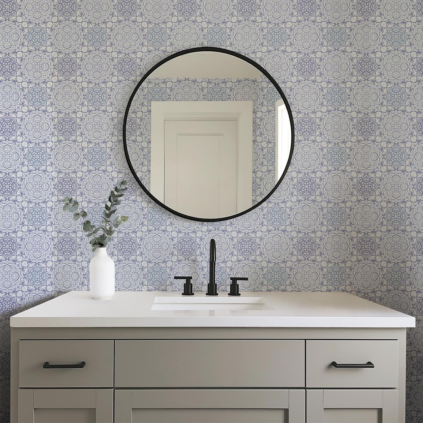Bathroom vanity with round mirror and patterned wall