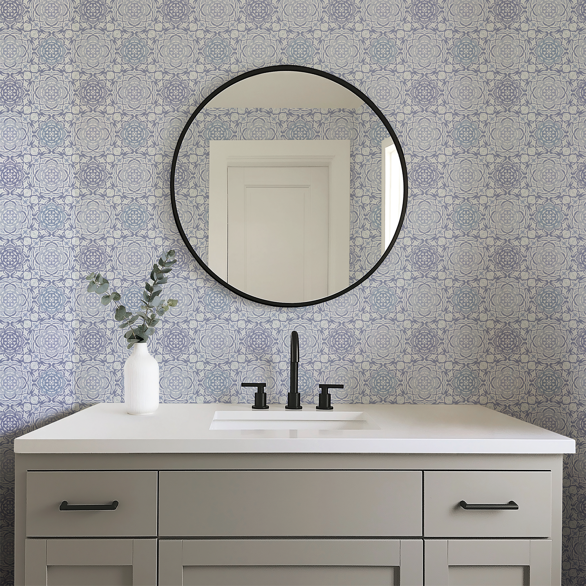 Bathroom vanity with round mirror and patterned wall