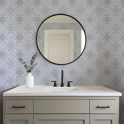 Bathroom vanity with round mirror and patterned wall