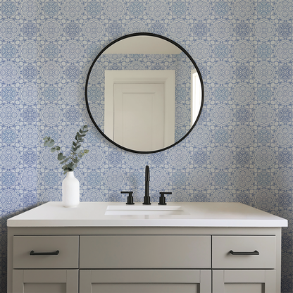 Bathroom vanity with round mirror and patterned blue tiles