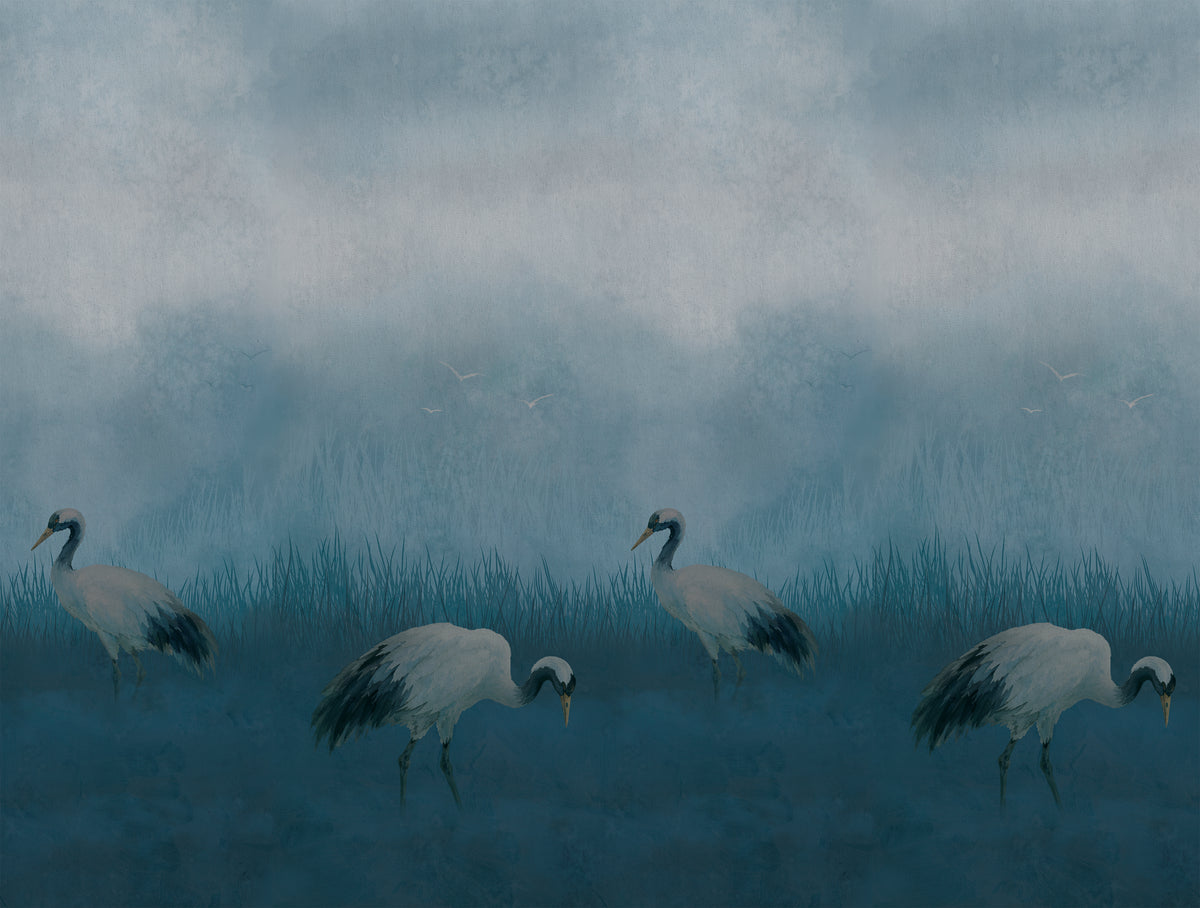 A misty blue-toned landscape artwork showing four white cranes walking through reeds under a cloudy sky.