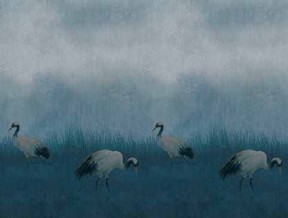 A misty blue-toned landscape artwork showing four white cranes walking through reeds under a cloudy sky.