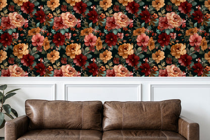 Brown leather sofa in front of a floral wallpapered wall.