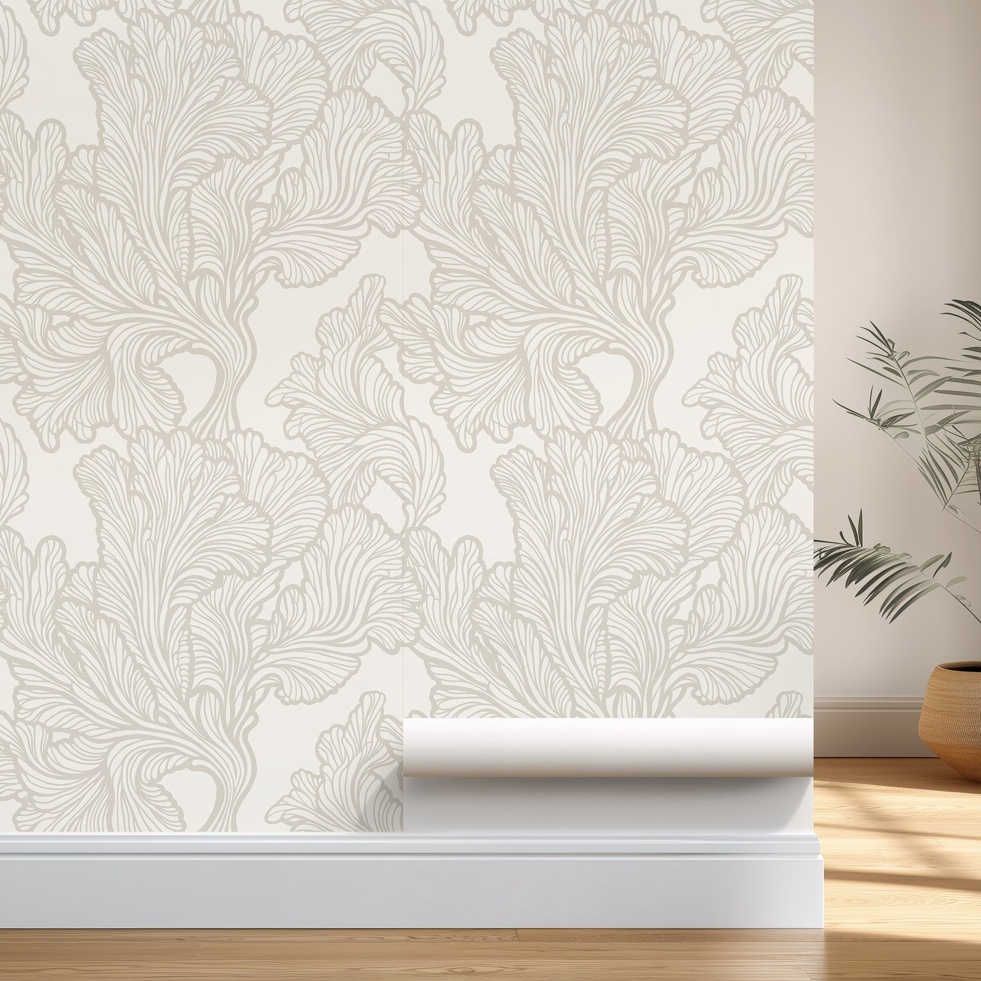 Roll of wallpaper with decorative leaf pattern on a plain wall.