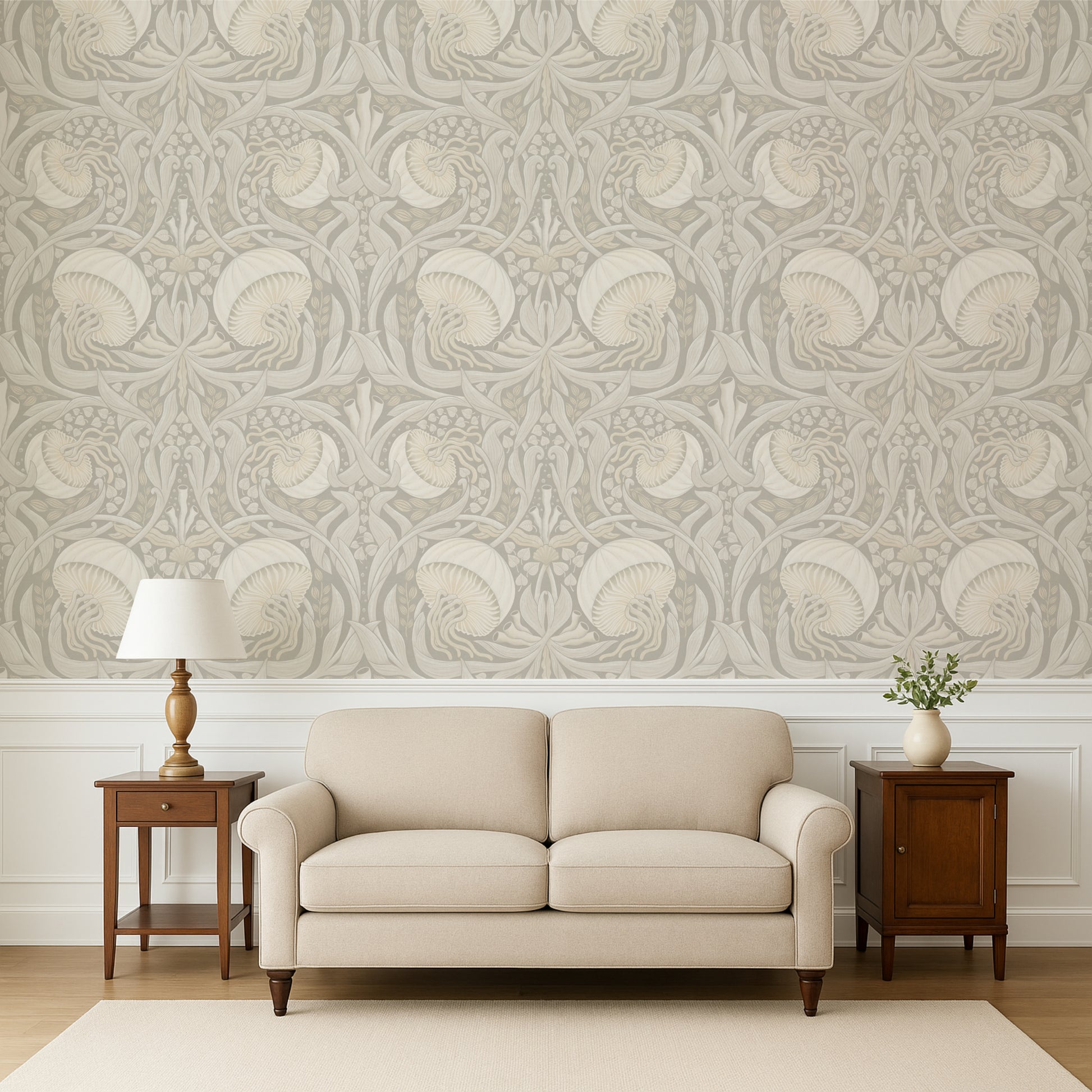 Beige sofa in a room with decorative wallpaper and wooden side tables.