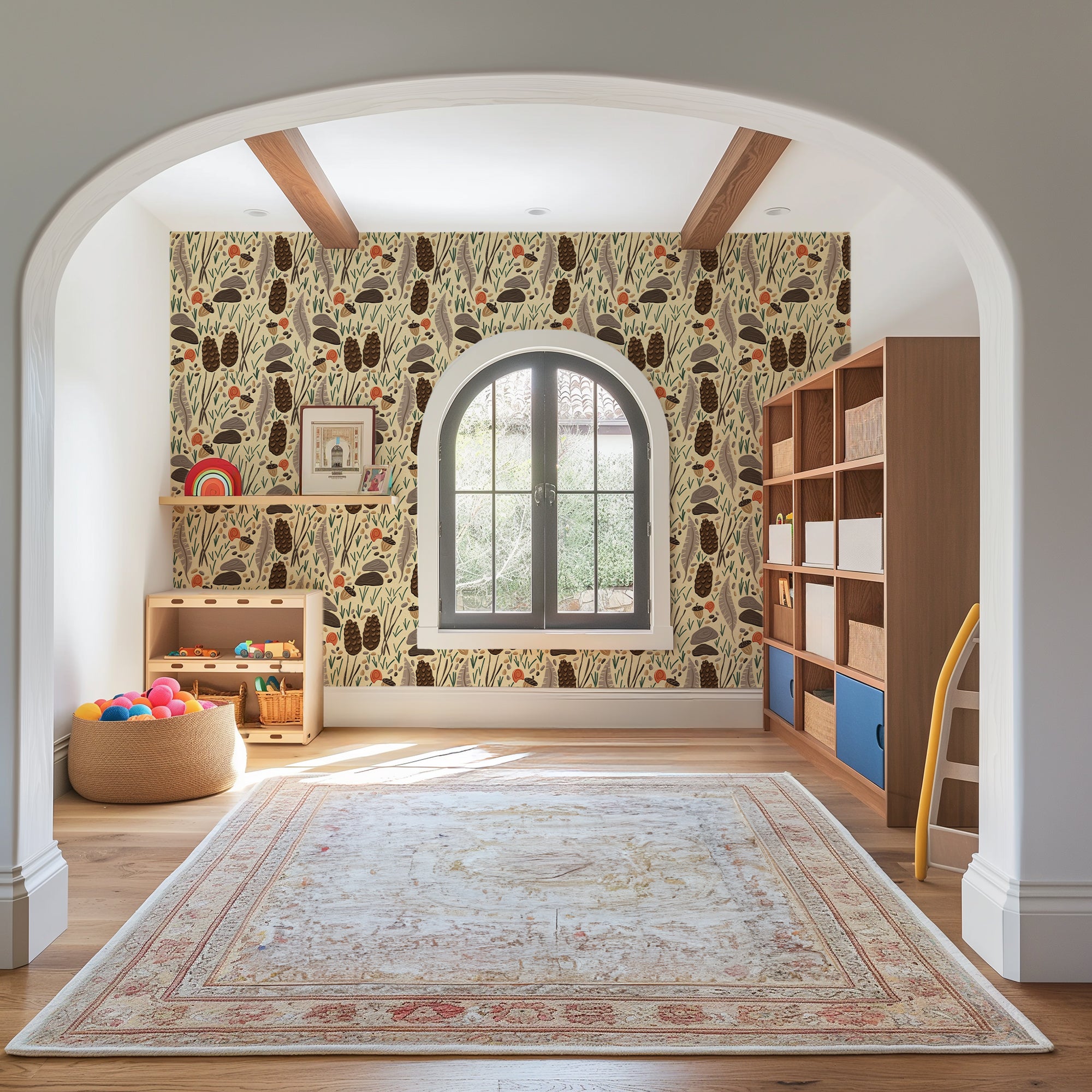 A styled children's room interior viewed through a white arched doorway, featuring a wall covered in a whimsical botanical patterned wallpaper. The wallpaper has a cream background with brown, black, and muted green tree and leaf motifs.