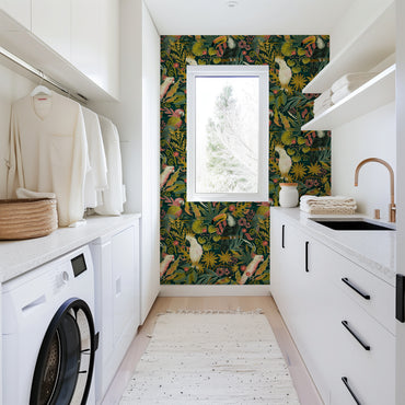 Modern laundry room with floral wallpaper, washing machine, and sink.