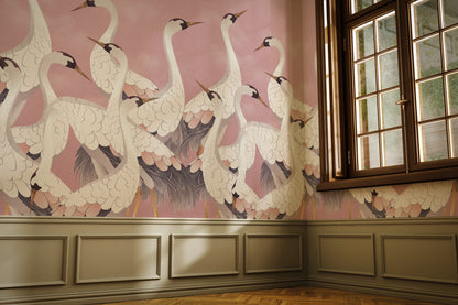 Wallpaper with crane design in a room with wooden flooring and a window.