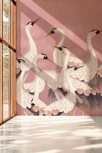 Decorative wall mural of cranes on a pink wall with a window on the left.