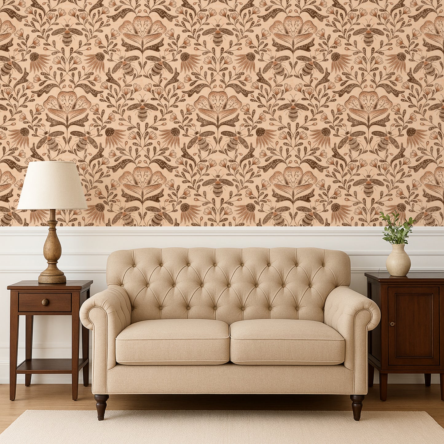 Beige tufted sofa in a room with floral wallpaper and wooden furniture.