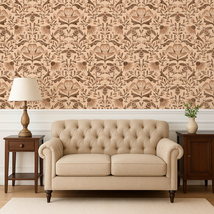 Beige tufted sofa in a room with floral wallpaper and wooden furniture.
