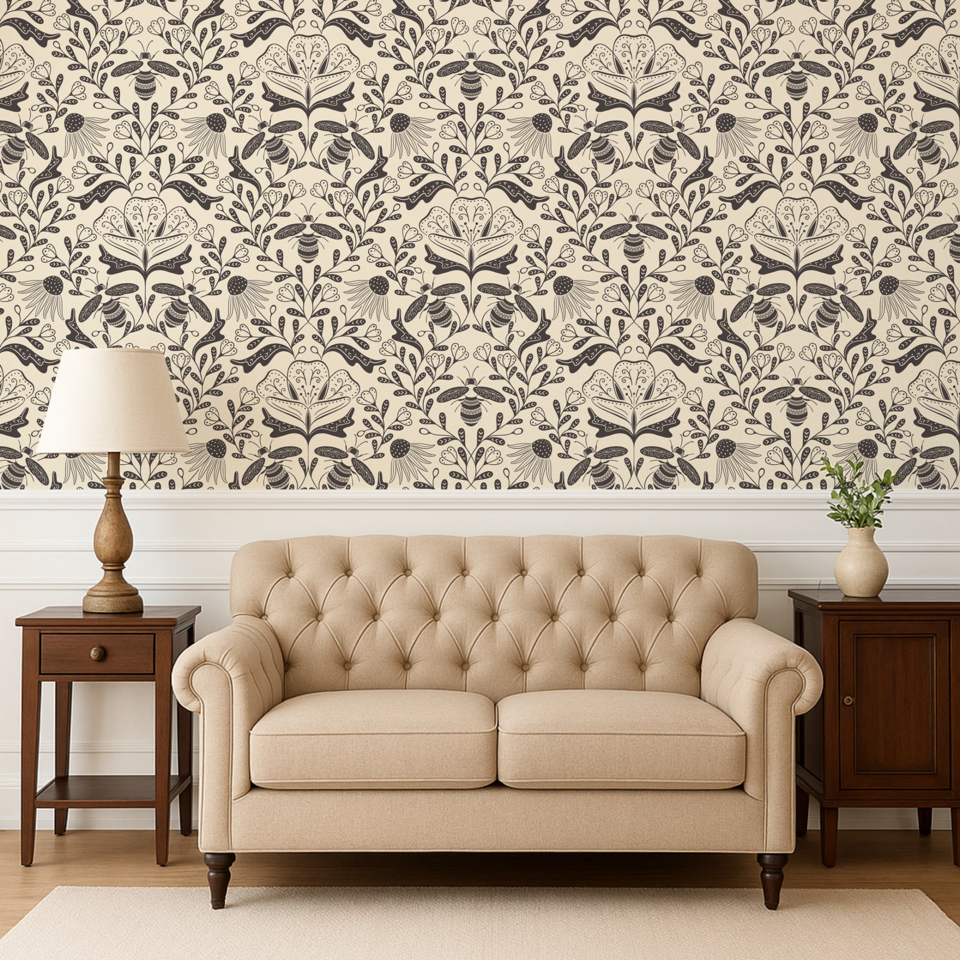 Beige tufted sofa in a room with decorative wallpaper and side tables.